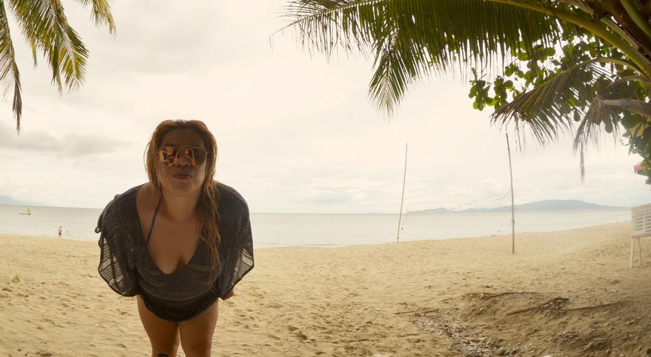 a girl in a swimsuit is relaxing on the beach