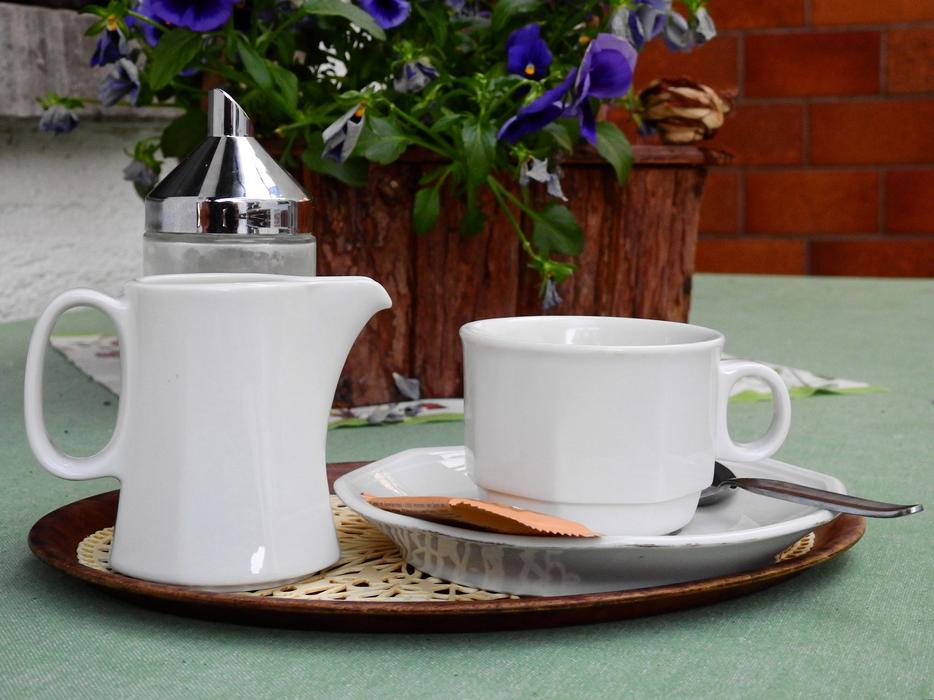 white cup and teapot