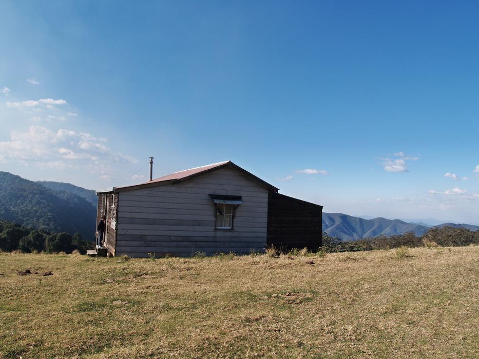 photo of a wooden hut on a hill