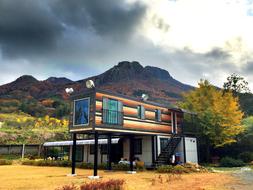 Building, among the colorful plants, near the mountain, on the beautiful landscape in Korea, in autumn