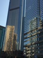 Shiny skyscrapers with the windows, in Hong Kong, at blue sky on background