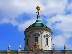 Beautiful and colorful roof of the old town hall in Potsdam, Germany, under the blue sky with white and grey clouds