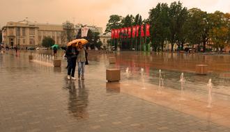 People, walking on the beautiful street in the rain, in autumn