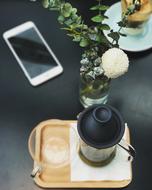 iPhone next to the tea on the table