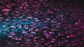 Close-up of the surface with water drops in beautiful pink light