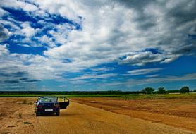 car in a wheat field