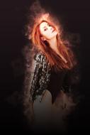 sexy red haired girl in front of smoke at darkness