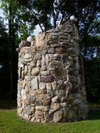 wild Stone tower in park at summer