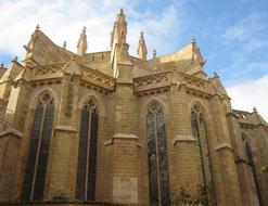 Beautiful, yellow building in Mallorca, in sunlight, under the blue sky with white clouds