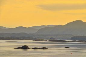 large mountains against a yellow sky