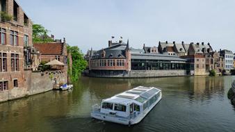 a ship sails along the canal in ghent, Belgium