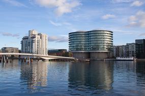 Beautiful landscape with the harbour of Copenhagen, Denmark, with the buildings, under the blue sky with clouds