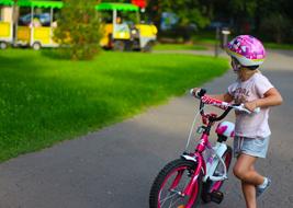 Child Girl with pink Bike in park