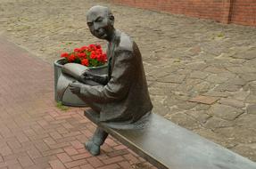 Statue Man with red flowers