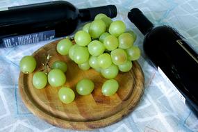 wine bottles near the grapes
