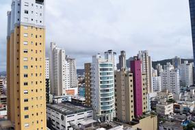 Colorful buildings in the city, under the white and grey clouds