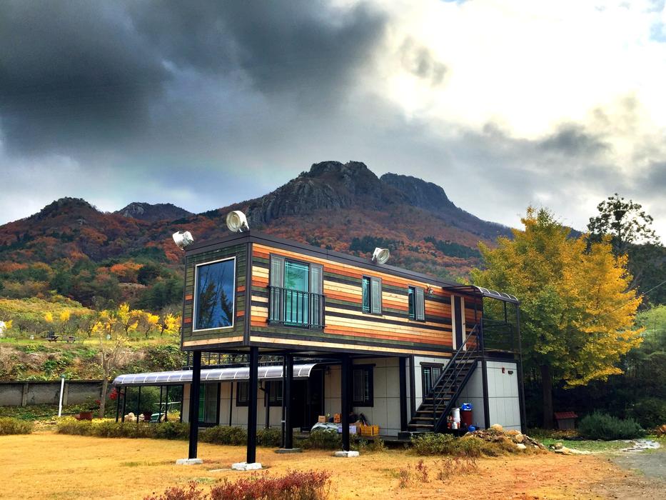 Building, among the colorful plants, near the mountain, on the beautiful landscape in Korea, in autumn
