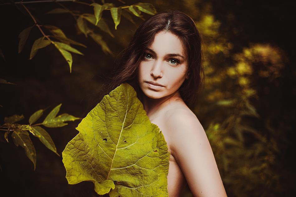 Girl and big leaf on a blurred background