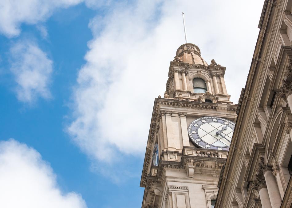 Beautiful and decorated clock tower at blue sky with white clouds on background in Melbourne, Australia