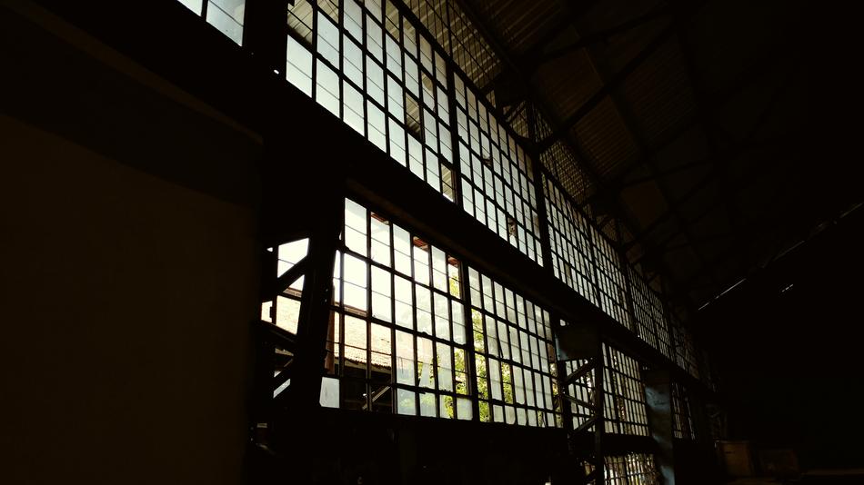 Old building with the silhouettes and light through the windows, among the darkness