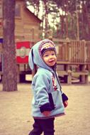 boy in the hood on the playground