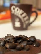 coarse coffee beans near the cup