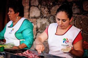 women cooking street food in huasca, mexico