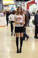 a girl with leaflets in her hands stands at the Expocentre