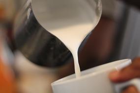 milk is poured into a mug