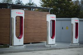 Electric charging station for Tesla cars, near the green trees