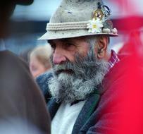 Portrait of the bearded pastor, with the hat, with the colorful flowers