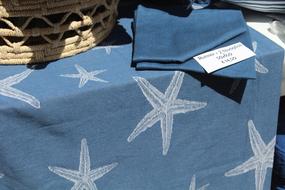 sale of blue tablecloths and napkins in the store in light