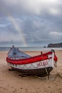 colored boat on the beach by the sea