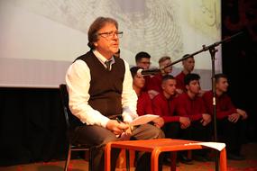 the artist reads the text on stage