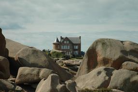 residential building behind stones near the sea