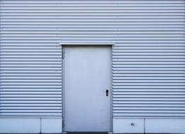 gray door and profile sheets on the garage wall