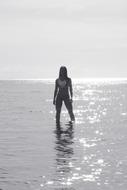 distant view of a posing girl in the water