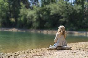 blonde girl by the lake on a sunny day