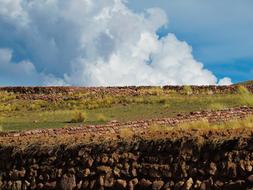 land of green grass and clouds