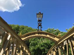 Beautiful, old bridge, with the lantern, near the green trees