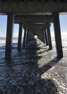 under the pier on the ocean