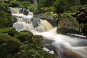 large waterfall flowing in the forest