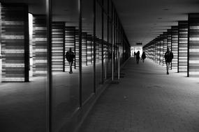 black and white, reflection of people in the facade of a building in Hamburg