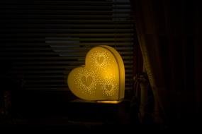 Yellow heart shape with heart shapes, among the darkness