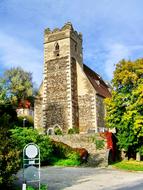 Beautiful and colorful Gothic church in St Michael's, Austria, among the colorful plants