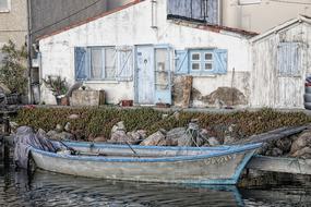 Old boat house, and boat on the river, in the village