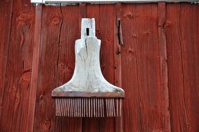 Old, white, wooden tool, on the wooden wall