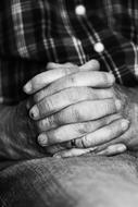 Black and white photo of a person holding hands together