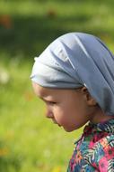 photo of a little girl with a gray scarf on her head