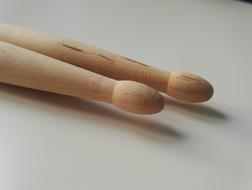 Wooden drum chopsticks on the white surface